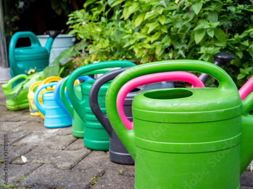 colorful watering cans at the garden
