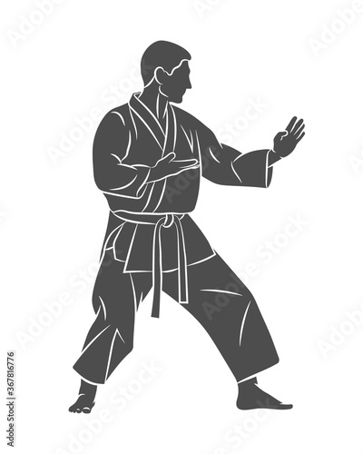 Man in kimono training karate on a white background