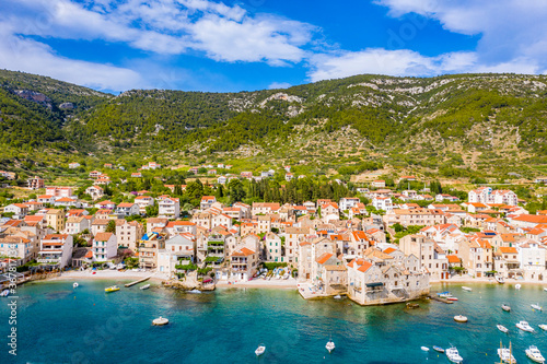 Aerial panoramic view of city Komiza - the one of numerous port towns in Croatia  is a lot of moored sailboats of a regatta
