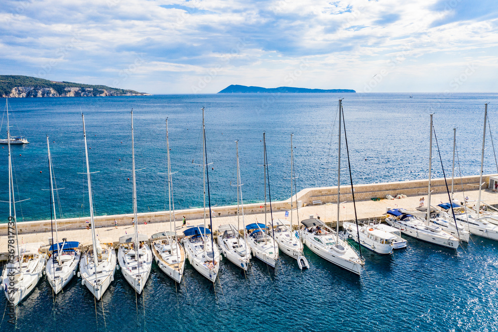Aerial panoramic view of city Komiza - the one of numerous port towns in Croatia, is a lot of moored sailboats of a regatta
