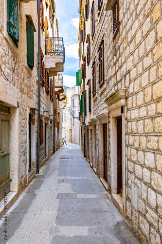 Komiza  Vis  Croatia  streets of Komiza town  Old stone houses in a charming narrow alley  typical Mediterranean architecture.