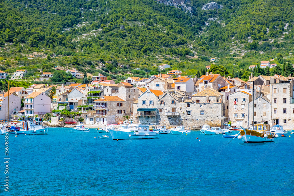 KOMIZA, CROATIA, VIS ISLAND coastal town lying on the island of Vis on the Adriatic Sea, view on port, moored boats