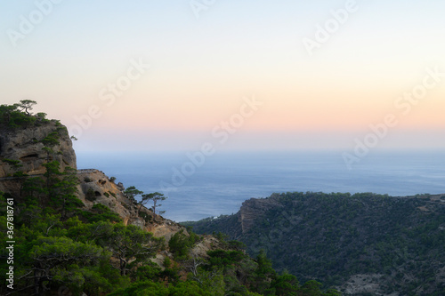 dusk mountain landscape with views of the Mediterranean sea and cloudless sky. Golden hour, haze or fog