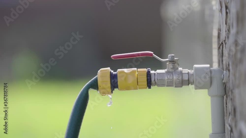 close up. male hand openes street water faucet in the summer photo