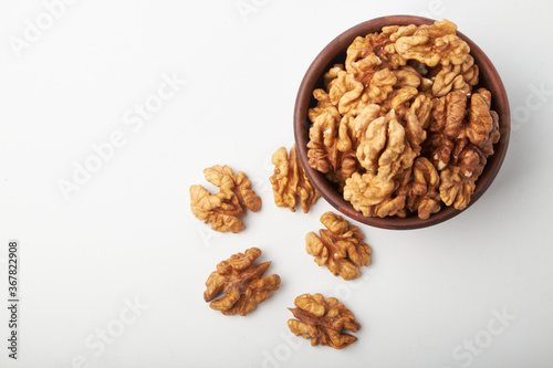 Walnut kernels on a wooden background.