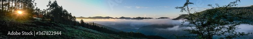 Sunrise among pine trees with the sea of clouds covering the Sopuerta valley © roberto