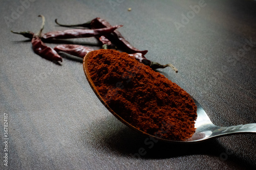 Indian Garam masala powder in bowl and it's ingredients colourful spices. Served over moody background. selective focus