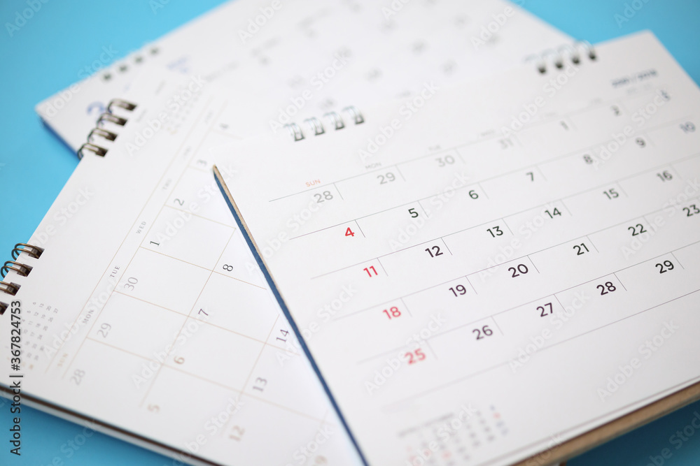 calendar page close up on blue background business planning appointment meeting concept calendar page close up on blue background business planning appointment meeting concept