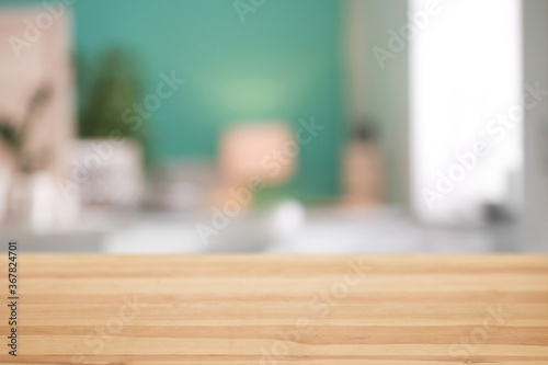 Wooden desk and blurred room on background. Home furniture