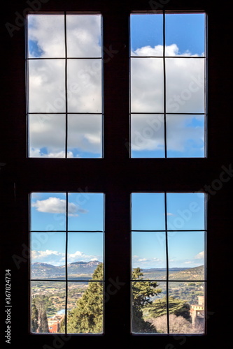 Outside the window you can see a beautiful landscape with clouds