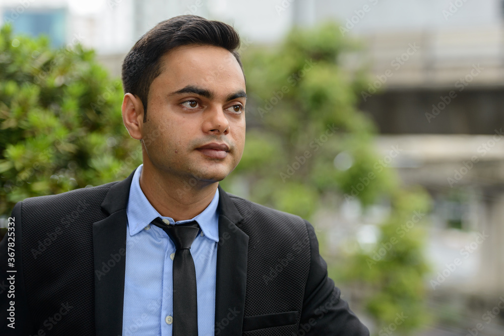 Young handsome Indian businessman in the city Young handsome Indian businessman in the city
