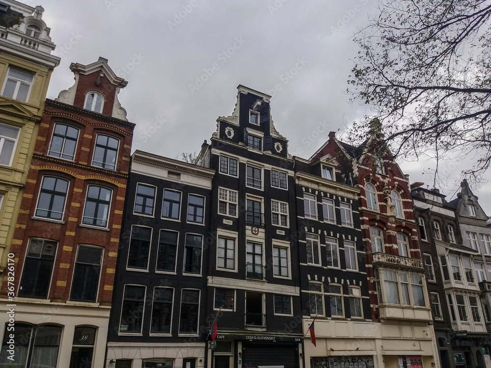 Singular architecture of Amsterdam, the most famous city of Netherlands. Small and big buildings completes this wonderful urban center.