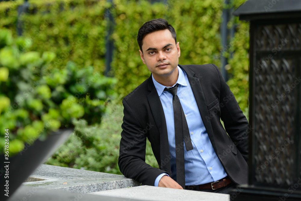 Young handsome Indian businessman in the city Young handsome Indian businessman in the city