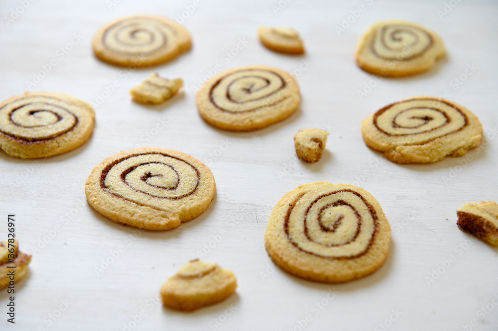 Shortbread cookies with cinnamon on a white wooden background. Cookie pattern. Selective focus.