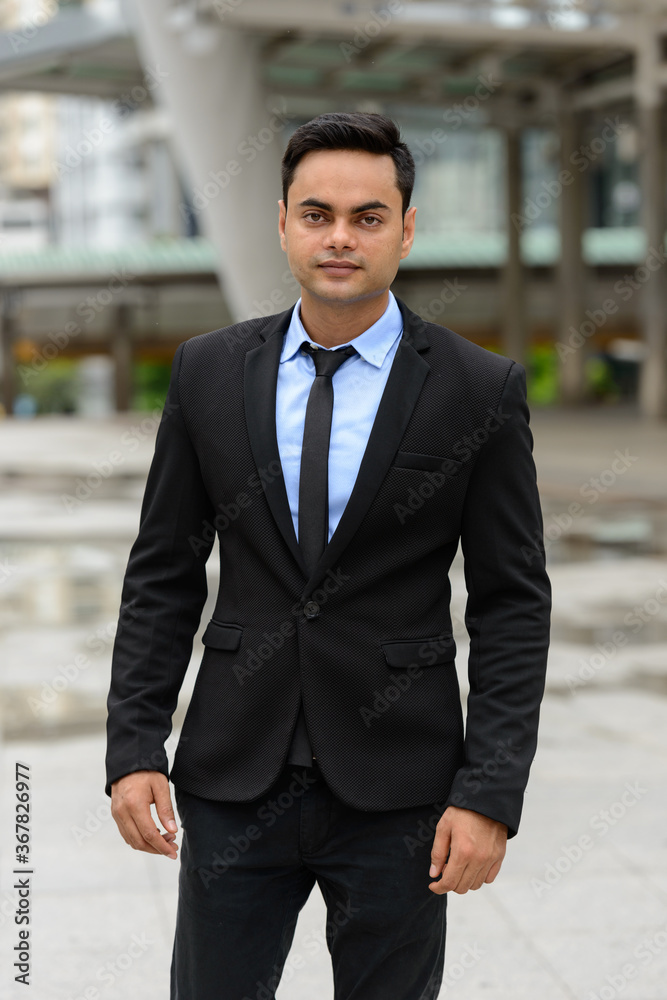 Young handsome Indian businessman in the city Young handsome Indian businessman in the city