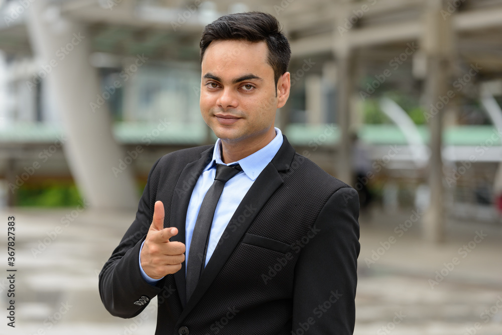 Young handsome Indian businessman in the city Young handsome Indian businessman in the city