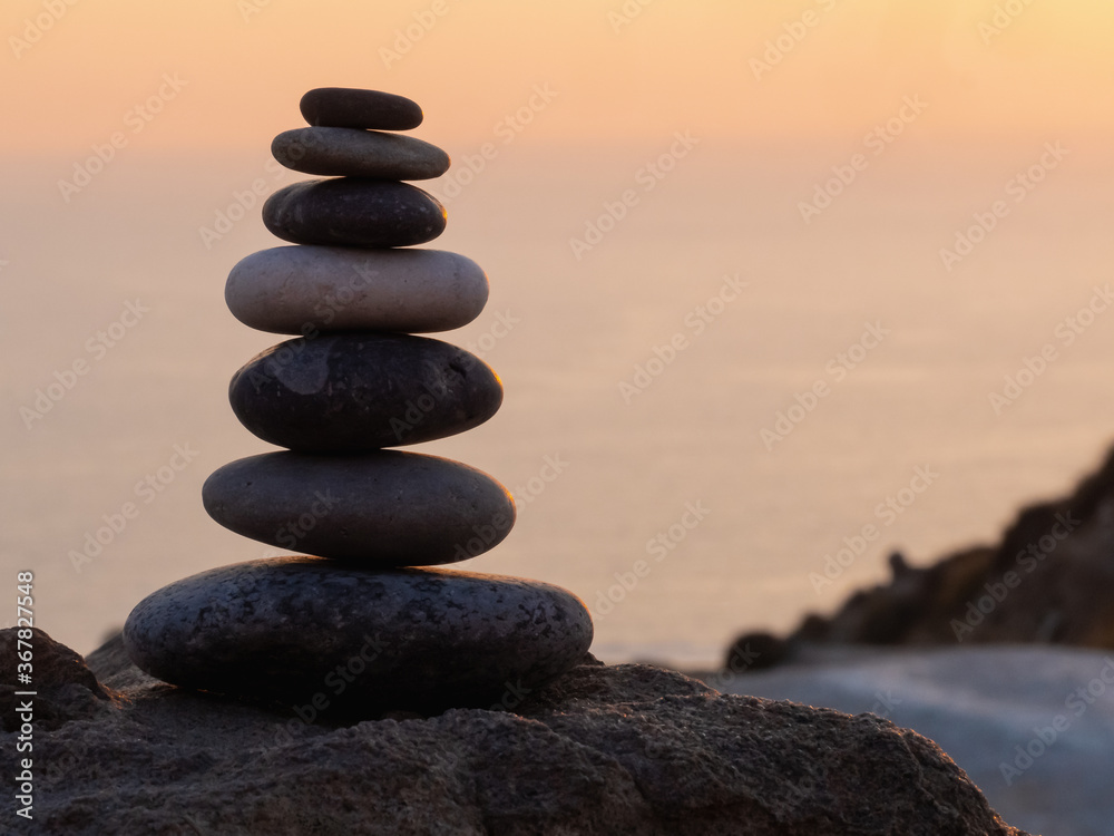 cairn at sunset, stones balances, pyramid of stones at sunset, concept of life balance, harmony and meditation cairn at sunset, stones balances, pyramid of stones at sunset, concept of life balance, harmony and meditation