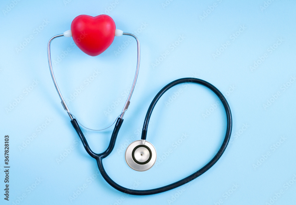 Stethoscope and red heart lying on color background. Health care, cardiology and medical concept Stethoscope and red heart lying on color background. Health care, cardiology and medical concept