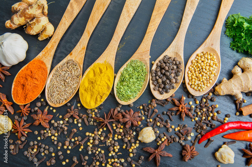 Various herbs and spices on the wooden spoons