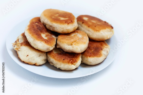 Traditional homemade fried patties or pies made of yeast dough in a rusticstyle on white plate