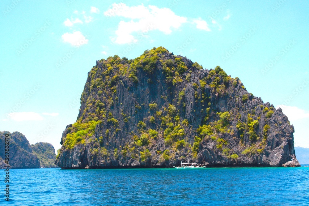 Beautiful landscape with rocks, mountain, turquoise clear blue water sea and green vegetation trees in the lagoon of El Nido, palawan, Philippines Islands.