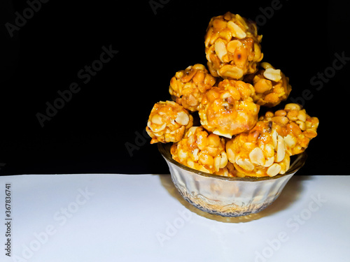 Photography Sweet Peanut balls or laddu made with roasted peanut and jaggery ,served in glas