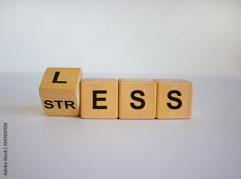 Having less stress or being stress-less. The word 'STRESS' and 'LESS' on wooden cubes. Beautiful white background, copy space. Having less stress or being stress-less. The word 'STRESS' and 'LESS' on wooden cubes. Beautiful white background, copy space.