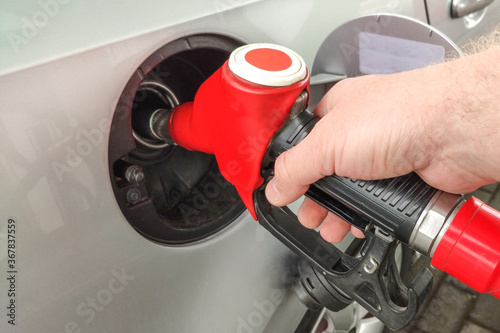 Refueling the car. The filling nozzle is inserted into the tank. fuel gasoline