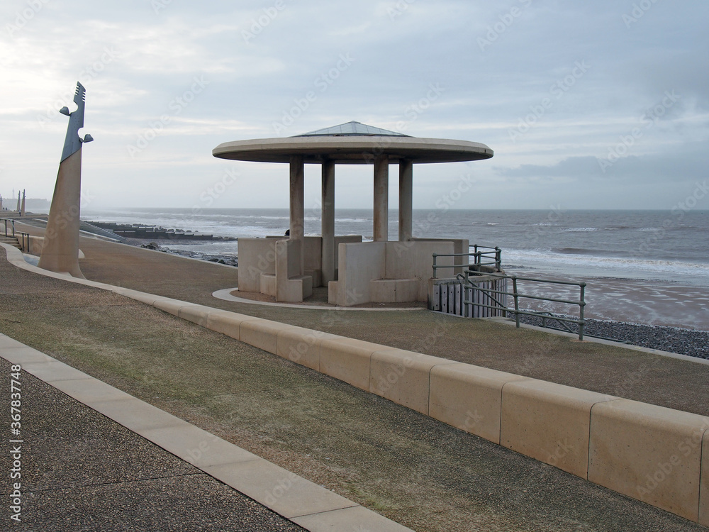 The curved promenade along the seafront at cleveleys in blackpool with steps leading to the sea with the town in the distance The curved promenade along the seafront at cleveleys in blackpool with steps leading to the sea with the town in the distance