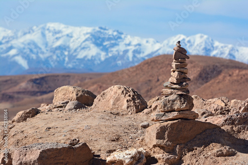 Stone tower on the top of hill in Ajt Bin Haddu, with a view of atlas mountains in the background. photo