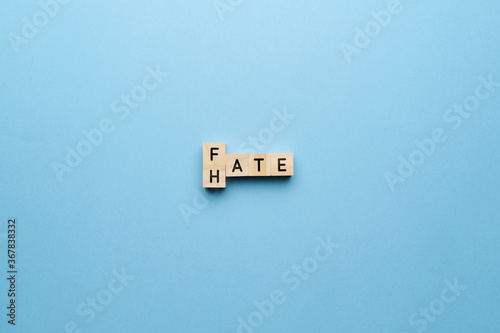 The concept of hate and fate. Letters on a blue background.