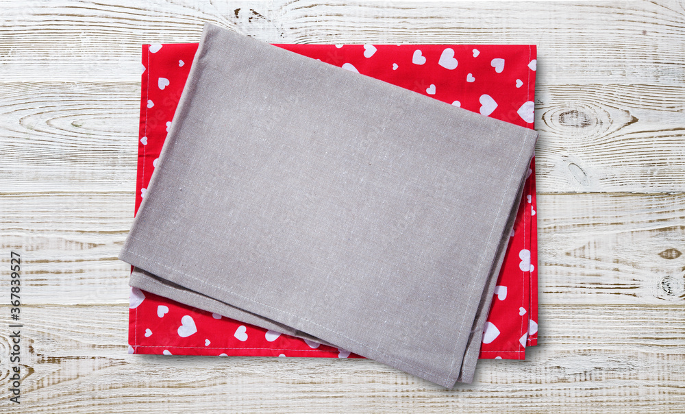 Fototapeta premium Red napkin. Stack of colorful dish towels on white desk