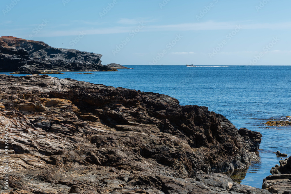 Rocky shore of the Mediterranean Sea in Spain on a beautiful sunny day