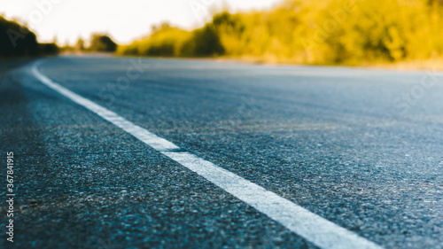 Marked asphalt road in the country close up