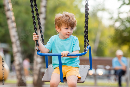 little boy of two years plays in a children's town in the summer. Children lifestyle © КРИСТИНА Игумнова