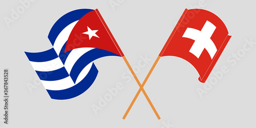 Crossed and waving flags of Cuba and Switzerland