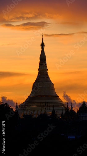 The stunning Shwedagon pagoda in Yangon  Myanmar. A stunning red filling the sky around this exciting building.