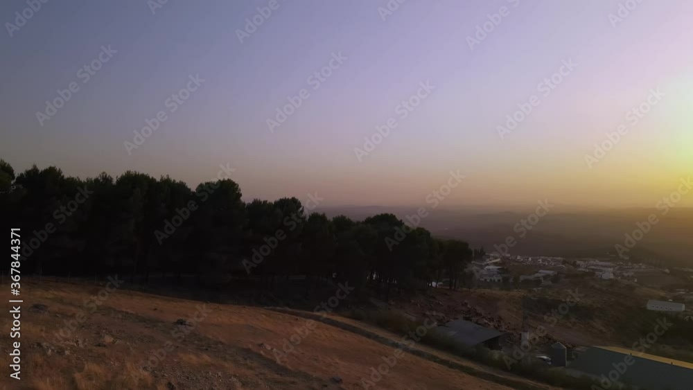 Colorful aerial sunset of small town surrounded by hills Colorful aerial sunset of small town surrounded by hills