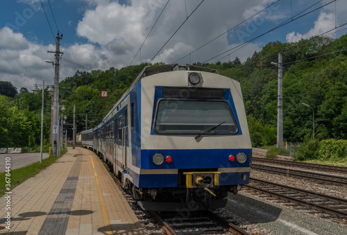 Payerbach-Reichenau station with electric blue old passenger unit in summer day