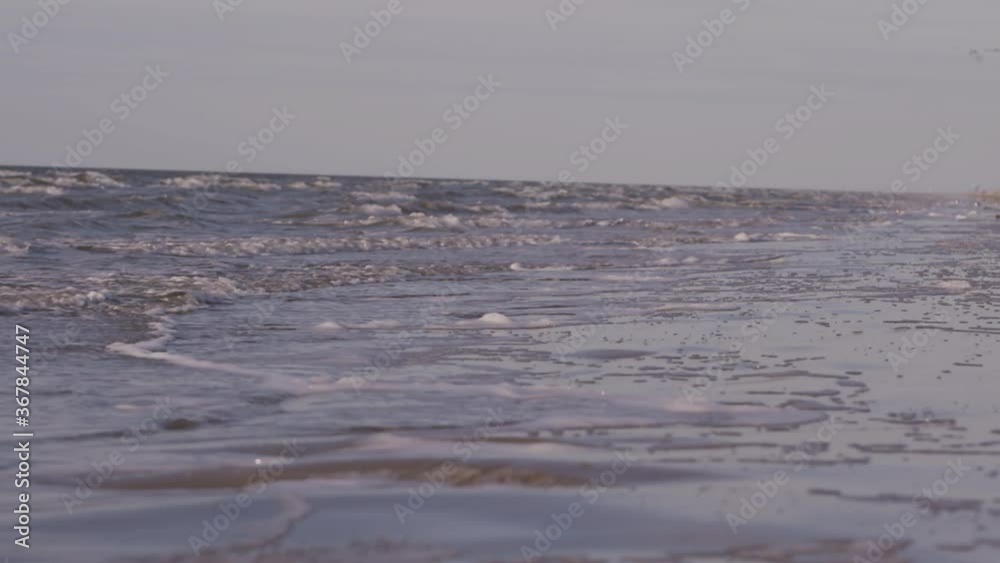 Sea waves rushing at the beach during sunset. Slow Motion Ocean White water Wave surf crashing. Sea waves rushing at the beach during sunset. Slow Motion Ocean White water Wave surf crashing.