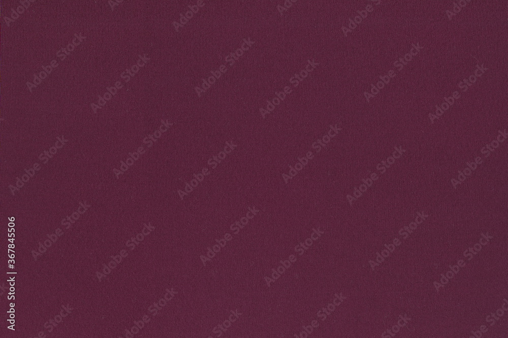 The texture of natural knitted fabric is a beautiful maroon color. Abstract monochrome background of soft wine-colored Burgundy fabric. The texture of natural knitted fabric is a beautiful maroon color. Abstract monochrome background of soft wine-colored Burgundy fabric.