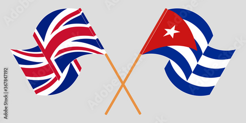 Crossed and waving flags of Cuba and the UK