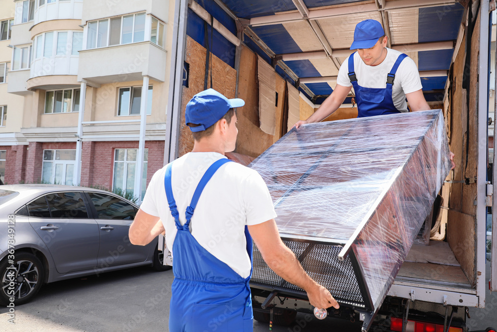 Loaders taking furniture from truck Stock Photo Adobe Stock