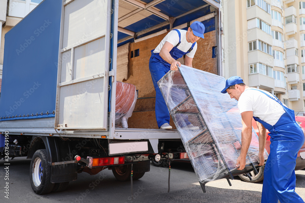 Loaders taking furniture from truck Stock Photo Adobe Stock