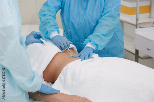 Woman in a beauty center doing a fat removal treatment
