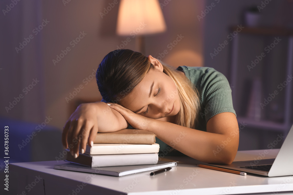 Student sleeping at table late in evening Student sleeping at table late in evening