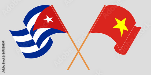 Crossed and waving flags of Cuba and Vietnam