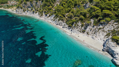 Aerial drone panoramic photo of famous turquoise paradise beach of Hovolo covered with pine trees, Skopelos island, Sporades, Greece