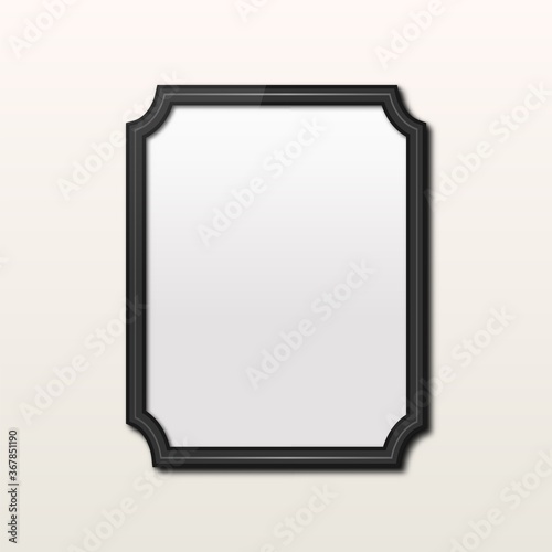 Realistic rectangle black frame isolated on grey wall. Vintage photo frame.