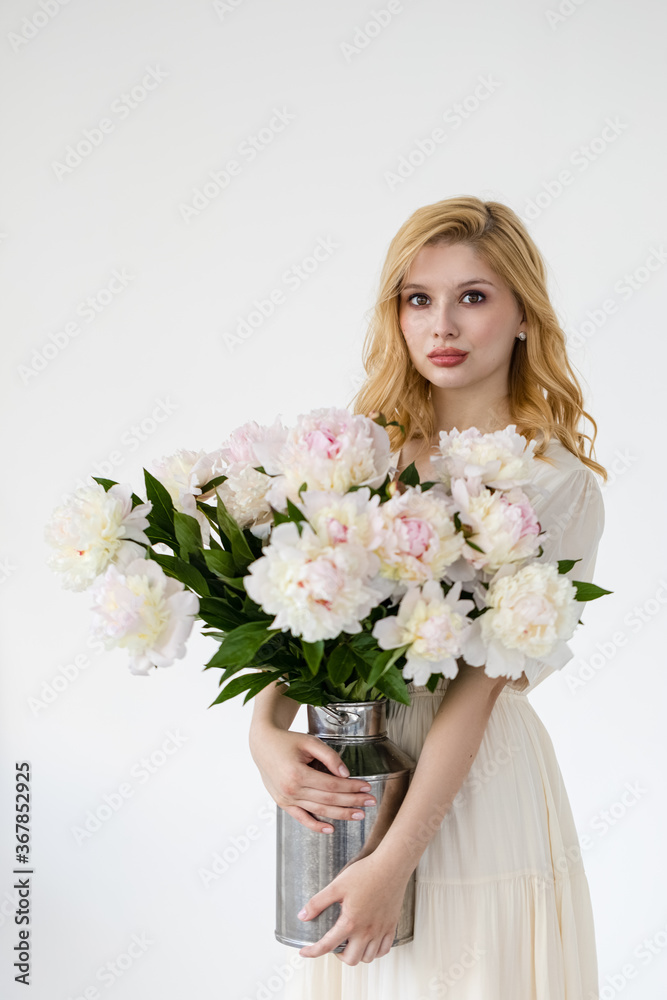 beautiful sensual girl with long blonde hair in dress with a bouquet of pink peonies flowers. Сoncept of feminity beautiful sensual girl with long blonde hair in dress with a bouquet of pink peonies flowers. Сoncept of feminity